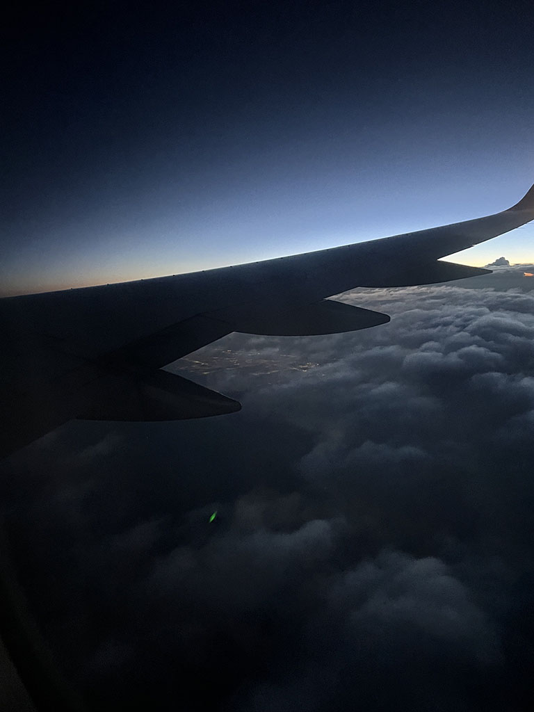 View of airplane wing out of plane window.