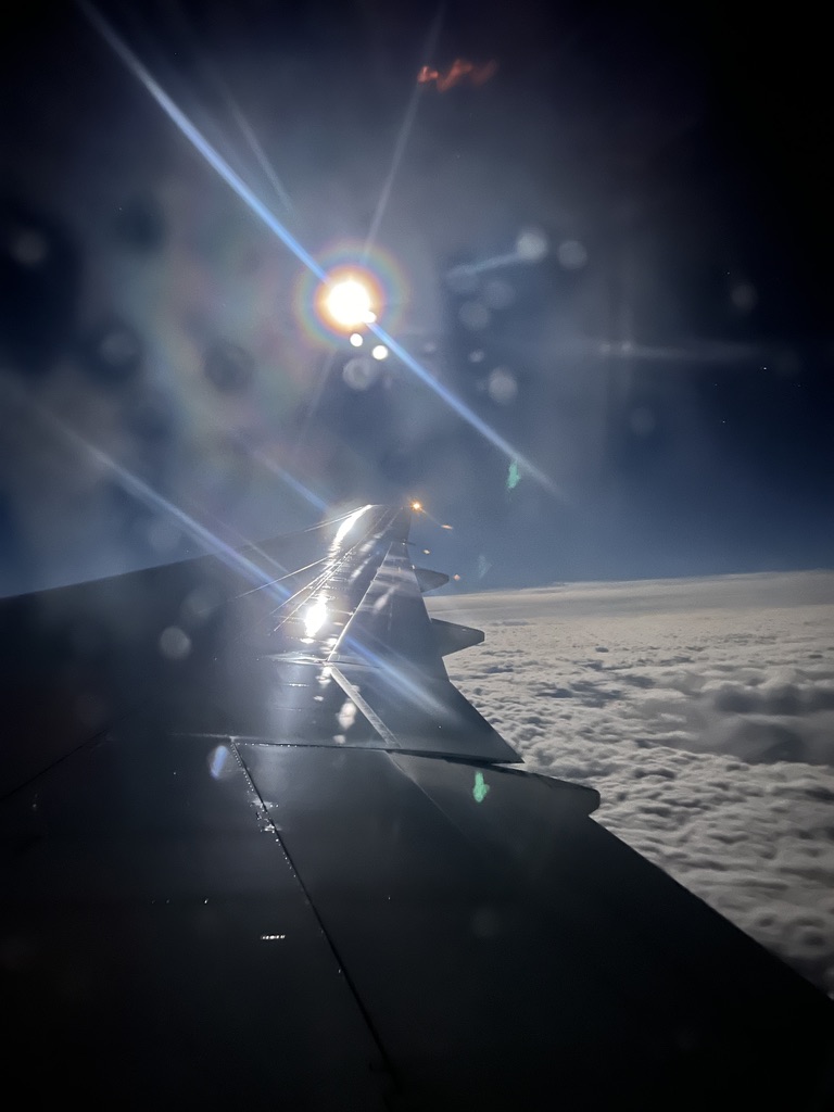 View of airplane wing out of plane window.