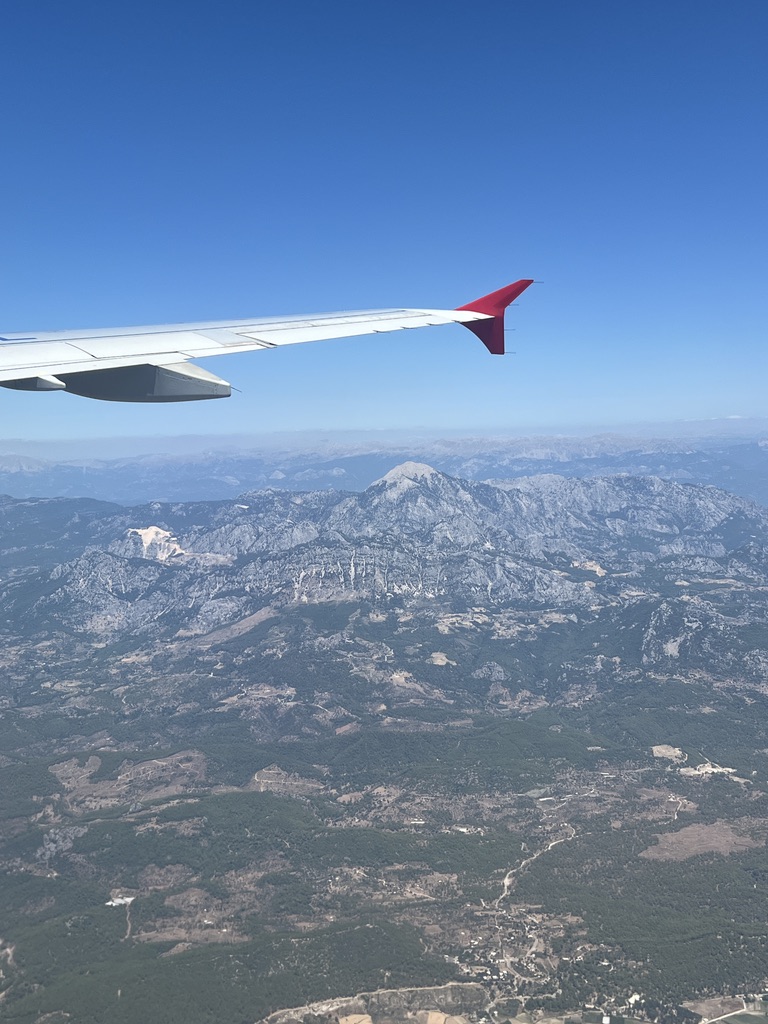 View of airplane wing out of plane window.