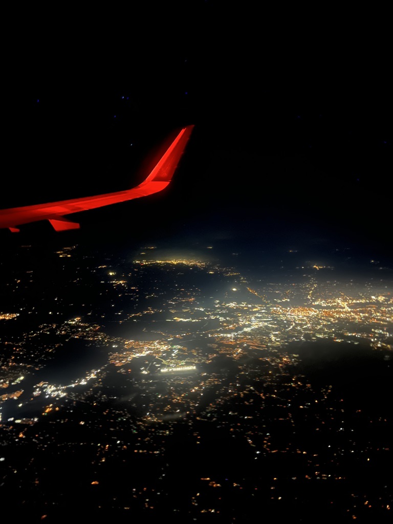 View of airplane wing out of plane window.