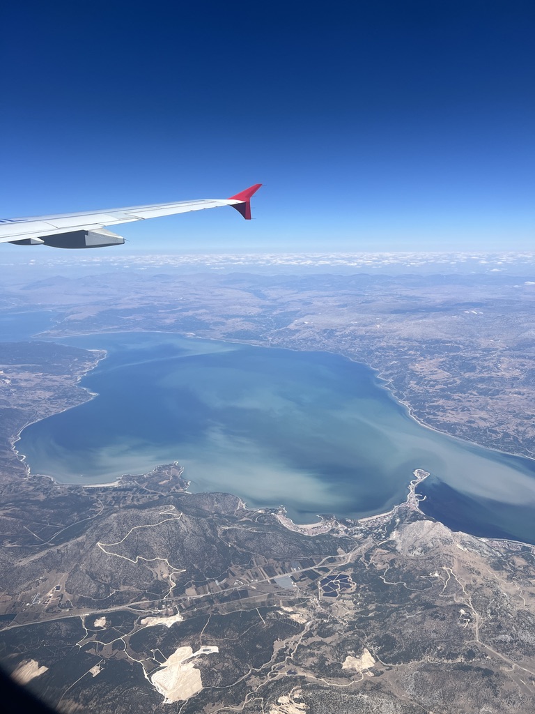 View of airplane wing out of plane window.