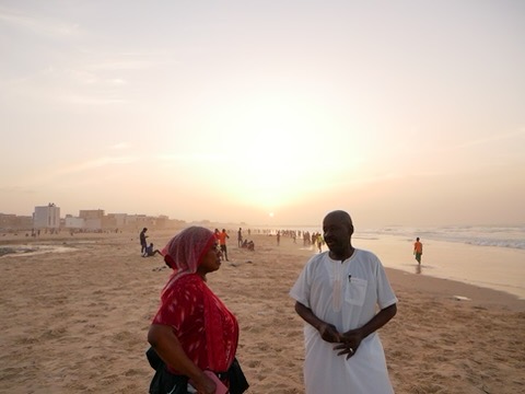 Couple on brightly lit beach.